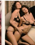 Two chicks in black lace lingerie cuddling on couch
